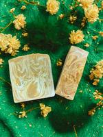 Two soap bars with floral patterns on a green background